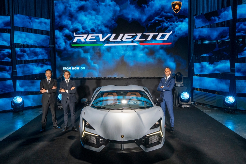 (From right) Automobili Lamborghini regional director for Asia Pacific Francesco Scardaoni, Automobili Lamborghini area manager South-east Asia Raffaele Garribba and Lamborghini Kuala Lumpur operation manager Christopher Teoh pose for a group photo during the Lamborghini  Revuelto launch at EX8, Petaling Jaya September 1, 2023. — Picture by Shafwan Zaidon