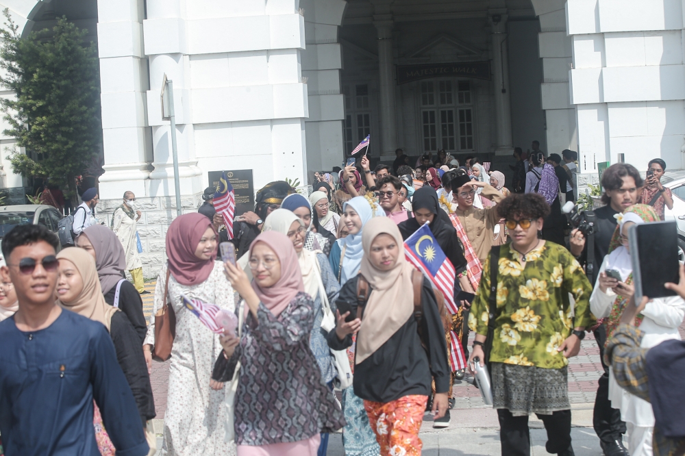 Many participants are seen wearing traditional Malay attire including sarongs, baju kurung, kebaya, traditional warrior attire and baju Melayu.. — Picture by Farhan Najib