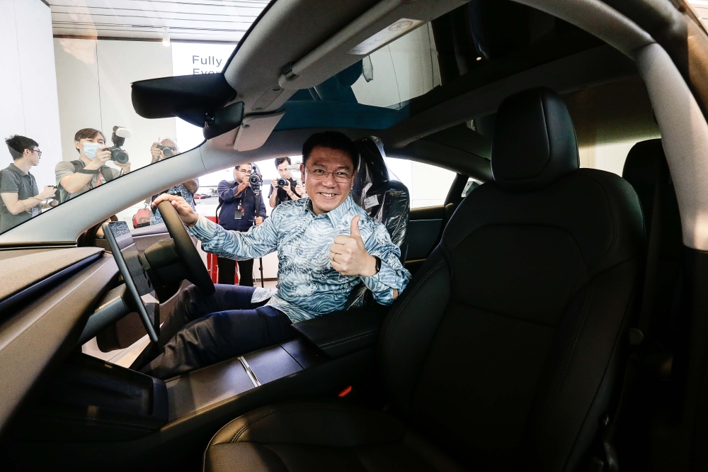 Local Government Developement Minister Nga Kor Ming poses for a photo at the opening of Tesla's First Experience Centre. — Picture by Sayuti Zainudin