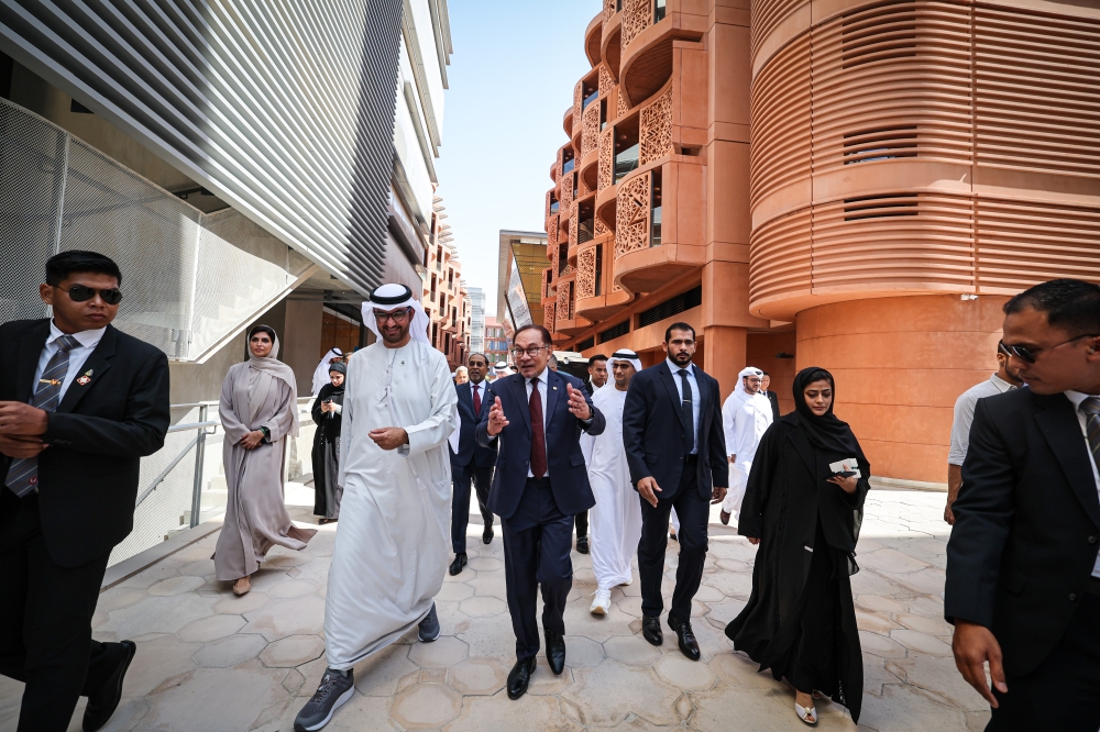 Prime Minister Datuk Seri Anwar Ibrahim (centre) with UAE’s Minister of Industry and Advanced Technology Sultan Ahmed Al Jaber during a visit to the Masdar City and Mohamed Bin Zayed University of Artificial Intelligence in Abu Dhabi October 6, 2023. — eNM pic
