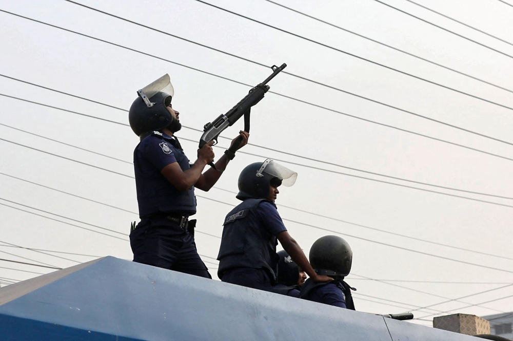 Police personnel fire rubber bullets to disperse garment workers staging a rally to demand a near-tripling of their wages in Ashulia on November 4, 2023. — eNM pic