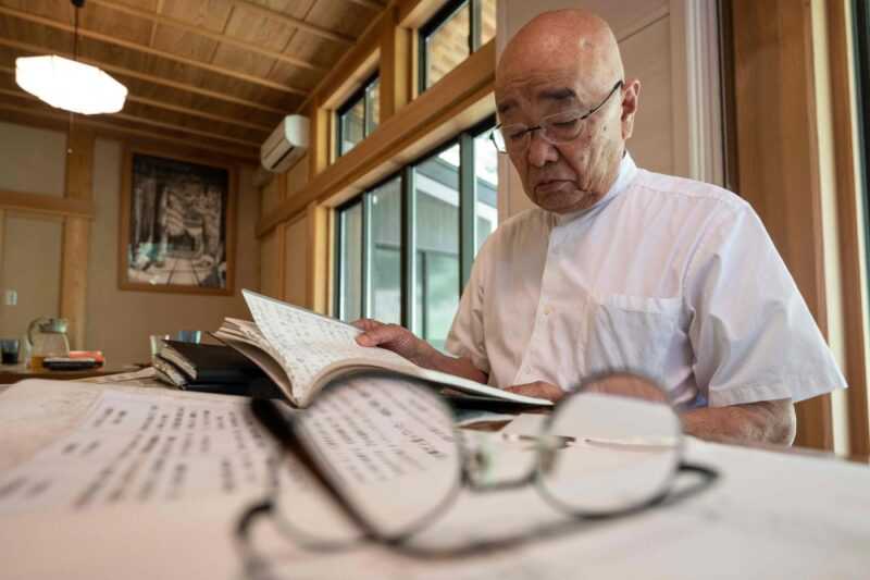 Chief Buddhist priest Eiichi Shinohara looking at a diary of a woman who was swindled out of millions of yen. — eNM pic
