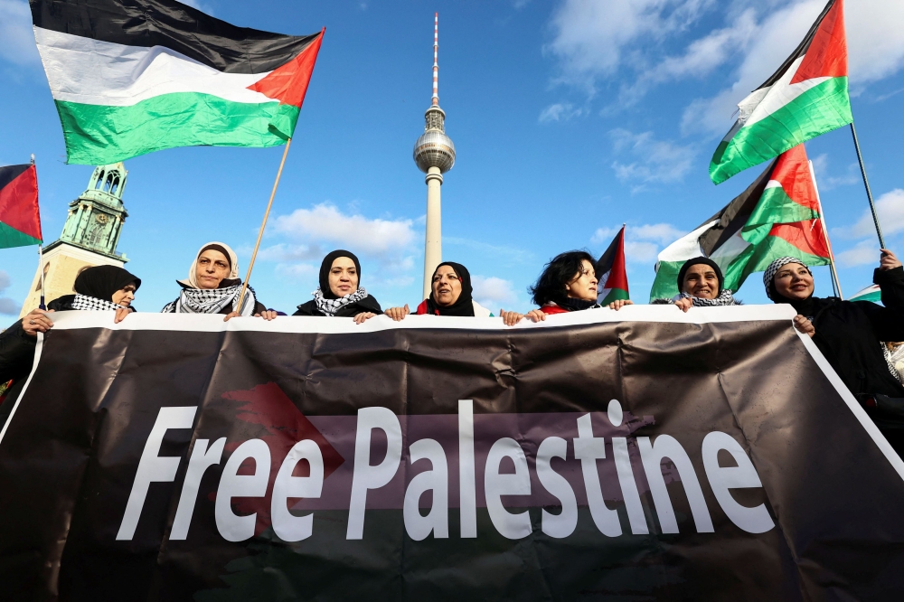 People hold a banner during a pro-Palestinian demonstration, amid the ongoing conflict between Israel and Palestinian Islamist group Hamas, near the TV Tower, in Berlin, Germany, November 4, 2023. — eNM pic
