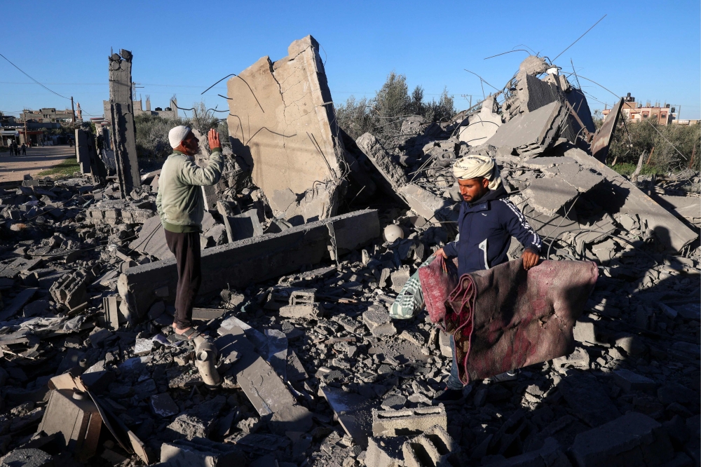 People look for salvageable items amid the rubble following Israeli bombardment in Rafah in the southern Gaza Strip on January 13, 2024, amid ongoing battles between Israel and Palestinian militant group Hamas. — eNM pic