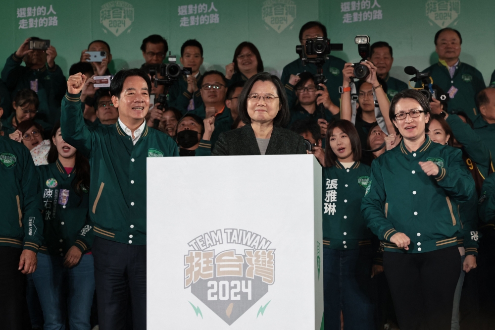 Taiwan’s President Tsai Ing-wen (centre), President-elect Lai Ching-te (left) and his running mate Hsiao Bi-khim attend a rally outside the headquarters of the Democratic Progressive Party (DPP) in Taipei on January 13, 2024, after winning the presidential election. — eNM pic
