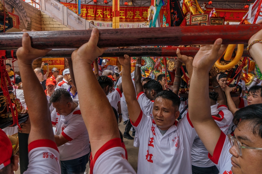 Devotees carry a statue during during the Wangkang ceremony. — Picture by Shafwan Zaidon