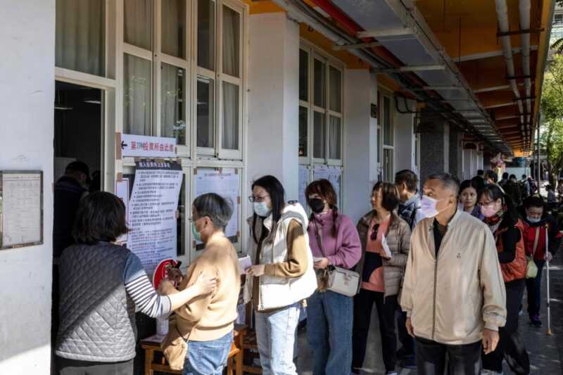 People wait in line to cast their ballots and vote in the presidential election at a polling station at an elementary school in New Taipei City January 13, 2024. — eNM pic