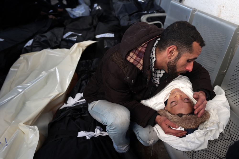 A man mourns over the body of his son killed in Israeli bombardment at the Najjar hospital in Rafah in the southern Gaza Strip on February 3, 2024, as fighting continues between Israel and the Palestinian Hamas group — eNM pic
