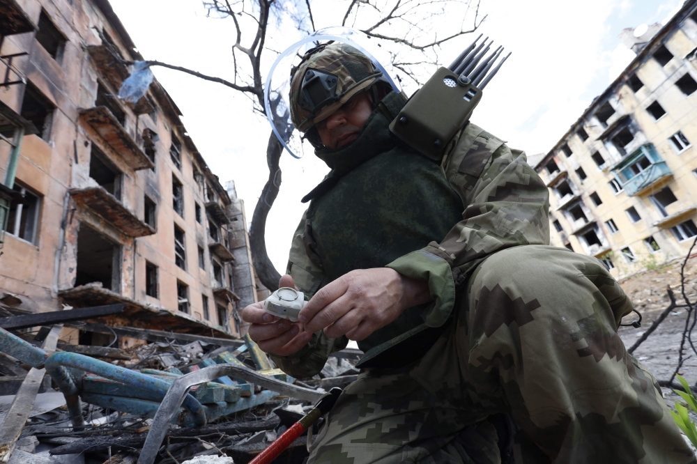 A Russian sapper checks a ruined building in Mariupol, in Russian-controlled Ukraine, on April 19, 2024 amid the Russia-Ukraine conflict. ― eNM pic