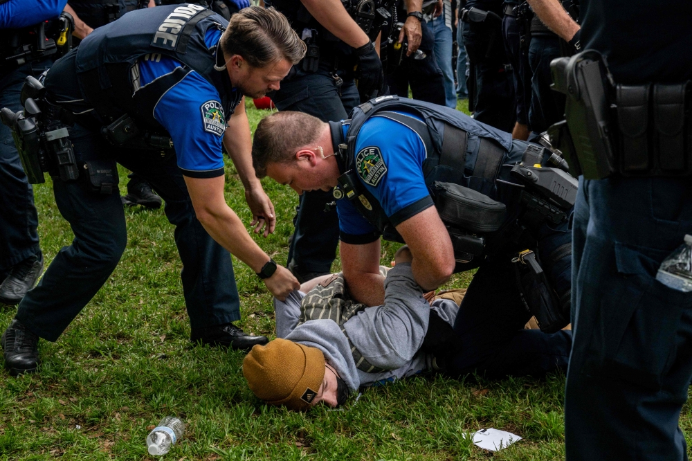 A student is arrested during a pro-Palestine demonstration at the The University of Texas, Austin. — eNM pic