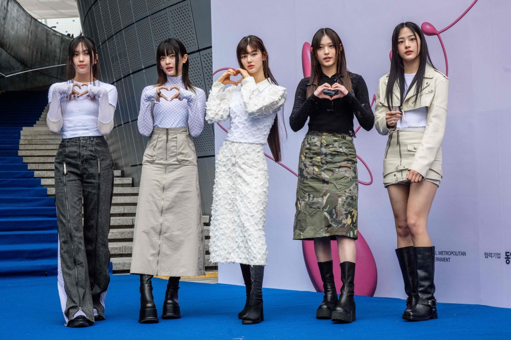 File photo of members of South Korean K-pop group NewJeans posing on the blue carpet at Seoul Fashion Week at Dongdaemun Design Plaza in Seoul on March 15, 2023. — eNM pic