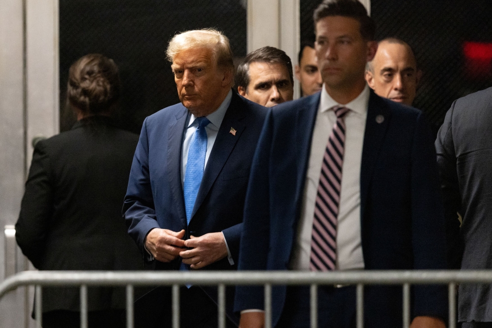File photo of former US President Donald Trump walking at Manhattan criminal court in New York, US, on Friday, April 26, 2024. — eNM pic