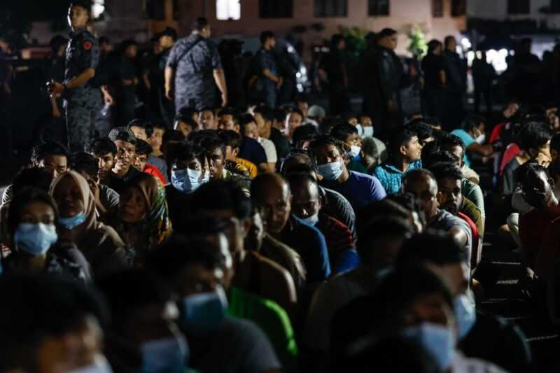Undocumented immigrants are gathered up during a raid by the Immigration Department at the Baiduri Apartment, Taman Tasik Kesuma Beranang, Semenyih January 19, 2024. — eNM pic