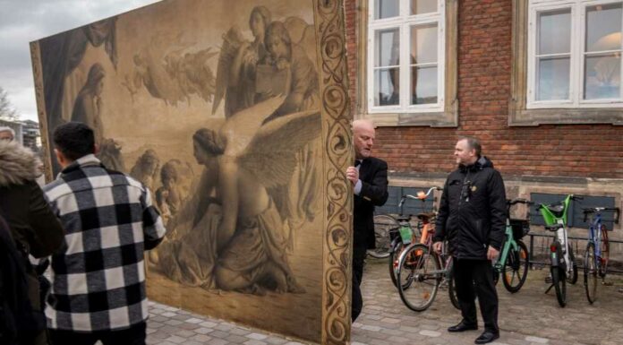 People carry a historic painting out of the Old Stock Exchange, Boersen, during a fire in the historic building, in Copenhagen, Denmark, April 16, 2024. — Ritzau Scanpix/Ida Marie Odgaard pic via eNM 