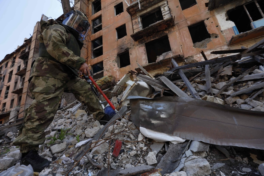 A Russian sapper checks a ruined building in Mariupol, in Russian-controlled Ukraine, on April 19, 2024 amid the Russia-Ukraine conflict. ― eNM pic