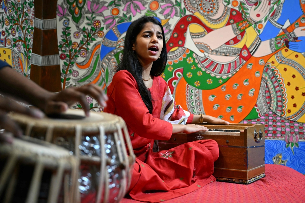 In this photograph taken on April 2, 2024, Indian folk singer Maithili Thakur sings after an interview with eNM at her residence in New Delhi. — eNM pic