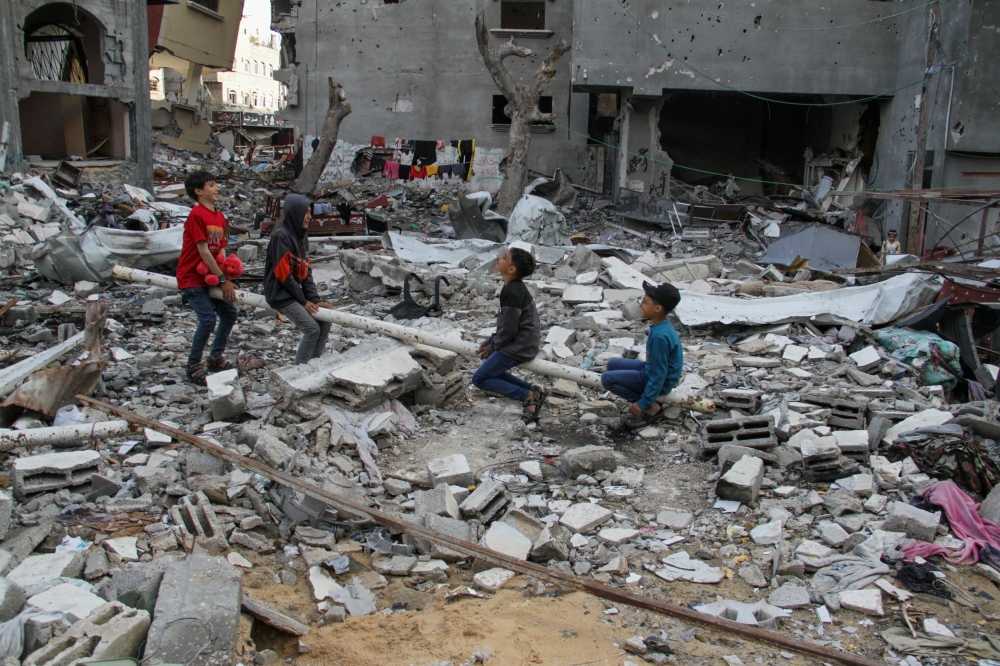 Palestinian children play amid the rubble at a park destroyed by Israel’s strike. — eNM pic