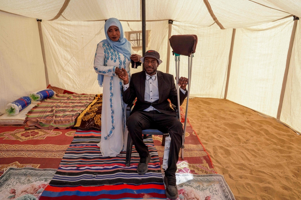 A bride and groom pose for a picture inside a tent ahead of a mass wedding ceremony in Khan Younis, in the southern Gaza Strip, on May 3, 2024, amid the ongoing conflict between Israel and the Palestinian militant group Hamas. ― eNM pic