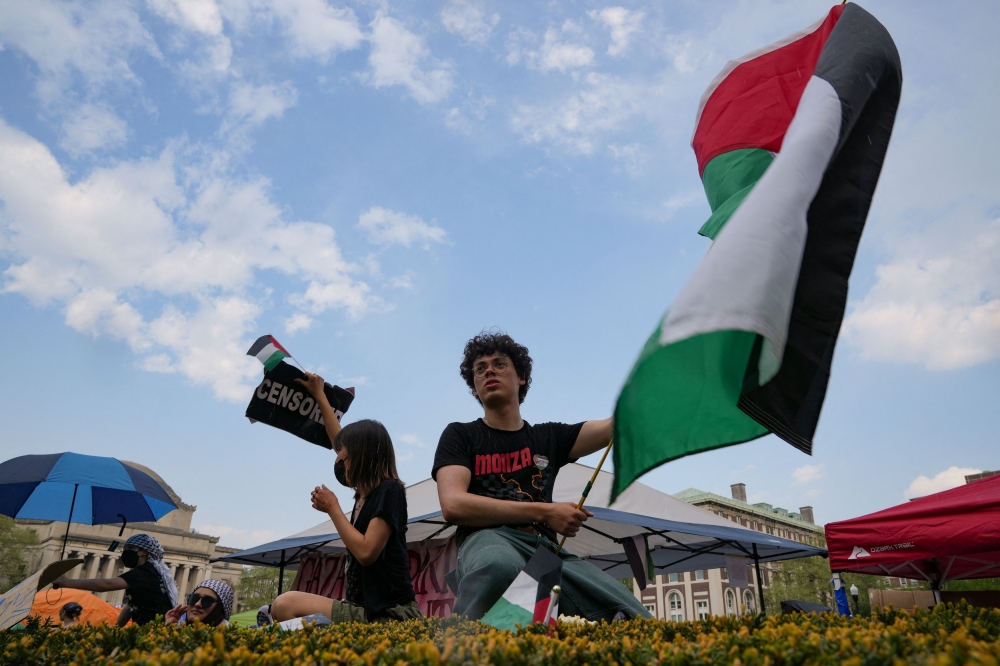 File photo of a protester holding a Palestinian flag as students rally on Columbia University campus at a protest encampment in support of Palestinians, despite a 2 pm deadline issued by university officials to disband or face suspension, during the ongoing conflict between Israel and the Palestinian Islamist group Hamas, in New York City. ― eNM pic