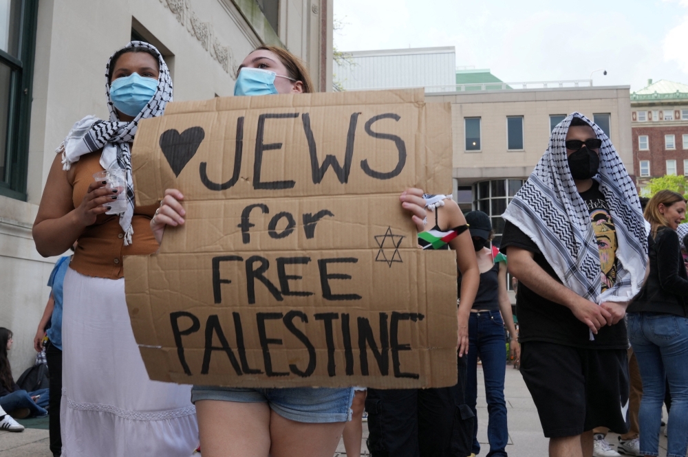 File  photo of a protester holding a sign as students rally on Columbia University campus at a protest encampment in support of Palestinians, despite a 2 pm deadline issued by university officials to disband or face suspension, during the ongoing conflict between Israel and the Palestinian Islamist group Hamas, in New York City, US, April 29, 2024. ― eNM pic