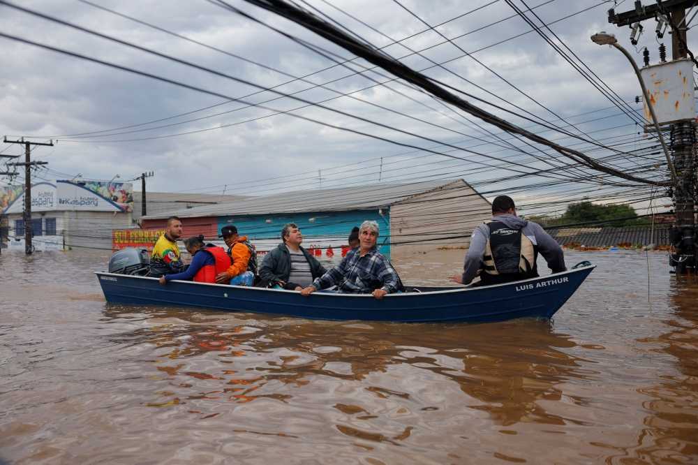 Authorities scrambled to evacuate swamped neighbourhoods as rescue workers used four-wheel-drive vehicles — and even jet skis — to manoeuvre through waist-deep water in search of the stranded. — eNM pic