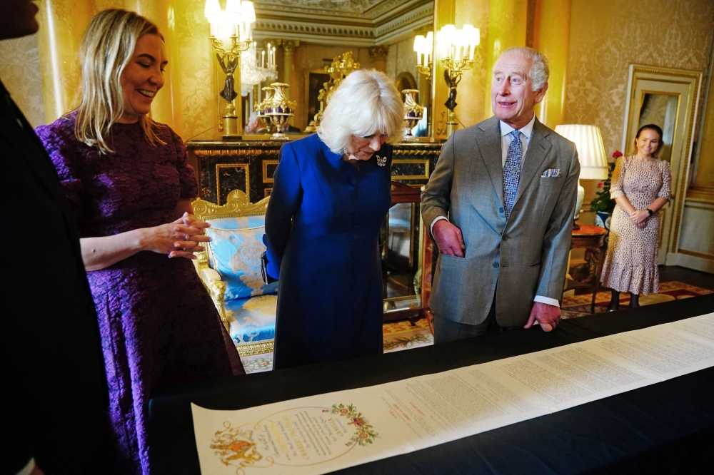 Britain's King Charles and Queen Camilla are presented with the Coronation Roll, an official record of their Coronation, by the Clerk of the Crown in Chancery, Antonia Romeo, at Buckingham Palace, central London May 1, 2024. — Victoria Jones/Pool/eNM pic