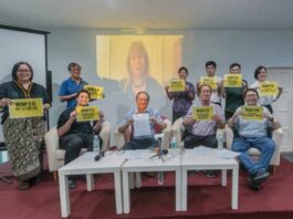 Sarawak Report editor Clare Newcastle-Brown appears on the screen during a group picture at Engage’s Freedom Fund press conference in Petaling Jaya May 9, 2024. — Picture by Raymond Manuel 