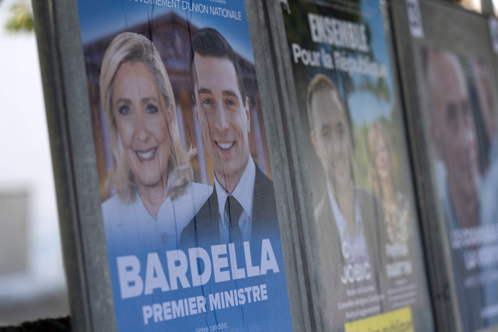 This photograph shows a campaign poster of the French far-right Rassemblement National (RN) party for the upcoming French legislative elections in Callac, western France, on June 27, 2024. — eNM pic