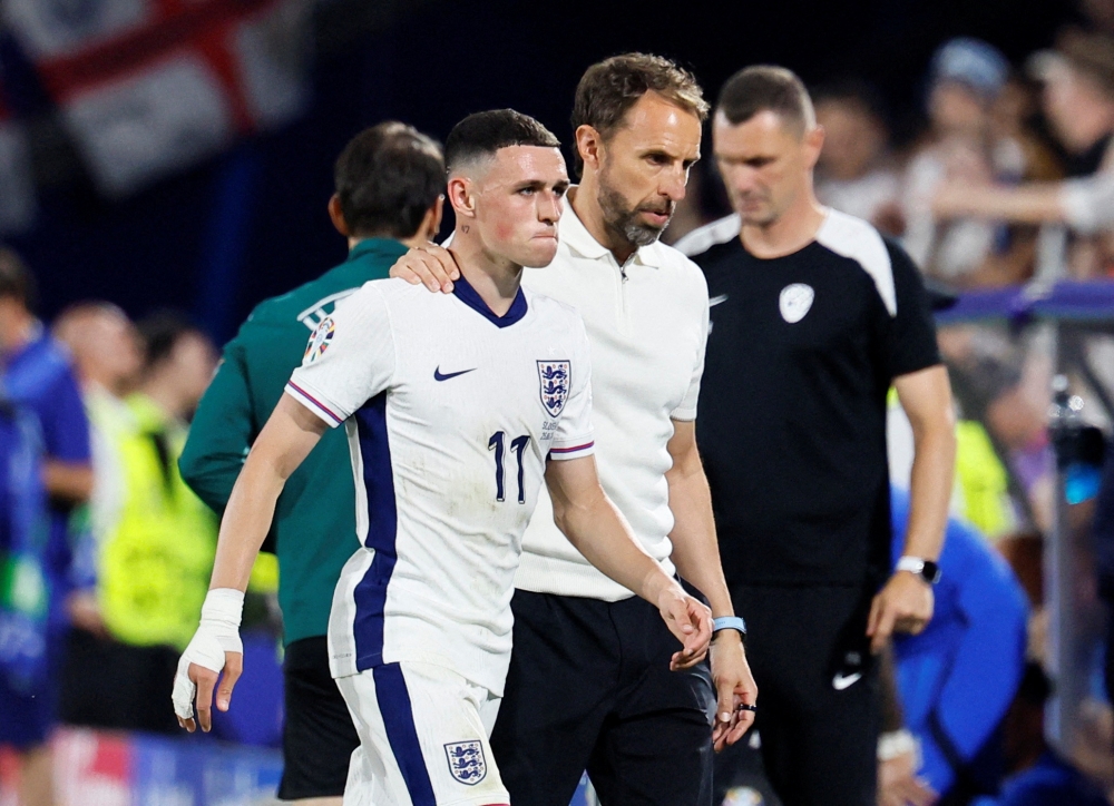 File phot of England’s Phil Foden with manager Gareth Southgate after being substituted during their Euro 2024 Group C match against Slovenia at the Cologne Stadium in Cologne, Germany, June 25, 2024. — eNM pic