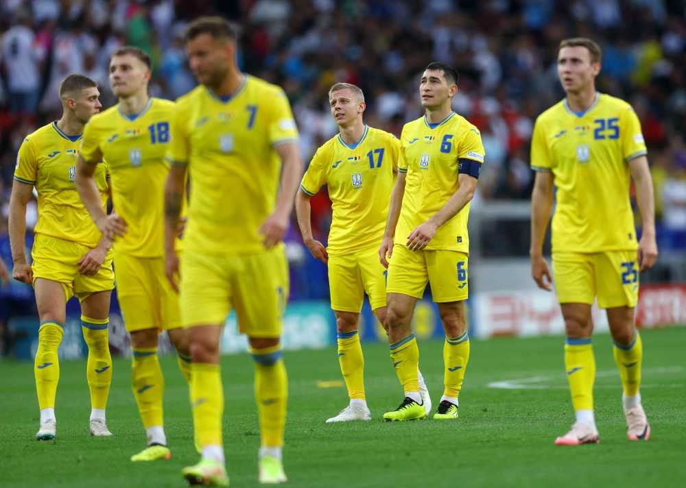 File photo of Ukraine’s Taras Stepanenko and Oleksandr Zinchenko looking dejected after their Euro 2024 qualifying match. — eNM pic