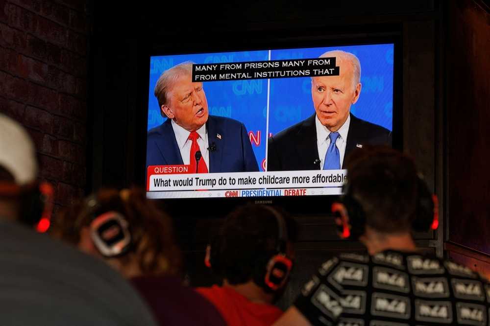 People watch the first Presidential debate between U.S. President Joe Biden and Republican candidate, former President Donald Trump, from a tavern in San Diego, California June 27, 2024. — eNM pic
