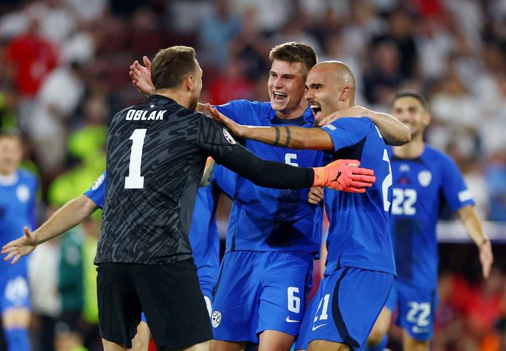 File photo of Slovenia’s Jaka Bijol, Jan Oblak and Vanja Drkusic celebrate after their Euro 2024 Group C match against England at the Cologne Stadium in Cologne, Germany, June 25, 2024. — eNM pic