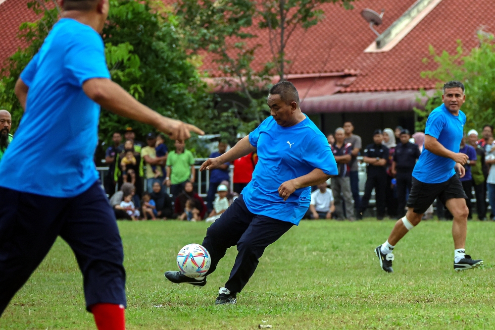 Kedah Menteri Besar Datuk Seri Muhammad Sanusi Md Nor is seen in action at a friendly football match between Akmal Nasrullah’s team and Muhammad Sanusi’s team at Taman Pekatra Ampat junction in Nibong Tebal June 30, 2024. — eNM pic