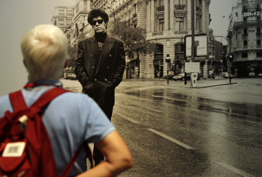A visitor observes a black and white photograph showing Spanish filmmaker Pedro Almodovar posing in Gran Via street, in Madrid, displayed as part of the exhibition ‘Madrid, Chica Almodovar’ (Madrid, Almodovar Girl), at the Centro Condeduque in Madrid June 20, 2024. — eNM pic